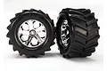 Two Traxxas 2.8 inch Maxx Chevron tyres pre-glued onto chrome-plated All-Star rims, shown against a plain white background.