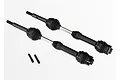 Two Traxxas steel-spline CV drive shafts with black rubber boots and two small metal grub screws on a white background.