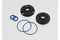 Traxxas centre differential rebuild kit components including two black plastic differential covers and four blue rubber O-rings on a white background.