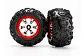 Two Traxxas 2.2 inch Canyon AT monster truck tires pre-glued onto chrome and red plastic wheels against a white background.