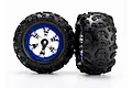 Two Traxxas 2.2 inch Canyon AT RC truck tires mounted on chrome and blue plastic wheels against a white background.