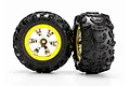 Two Traxxas 2.2 inch Canyon AT RC truck tires pre-glued onto yellow and chrome multi-spoke wheels against a white background.