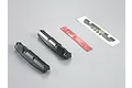 Killerbody 1/10 Toyota Land Cruiser 70 dashboard parts including two black plastic dashboard sections, a strip of double-sided tape, and a decal sheet.