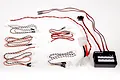 Axial Night Vision System LED light kit for RC vehicles, featuring a central control box, multiple LED light strings, and power connectors.