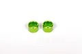 Two small green anodized aluminium cylindrical spacers for RC vehicles.