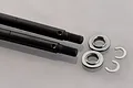 Losi rear axle shaft set including two black metal axle shafts, two silver spacers, and two metal C-clips on a grey background.