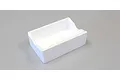 A white rectangular styrofoam stand with a contoured cutout on one side, designed for the Kyosho RC Surfer 4.