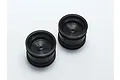 Two black Kyosho RC car rear rims viewed from a high angle against a plain white background.
