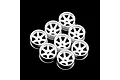 A cluster of eight white plastic RC car wheel rims arranged on a black background.