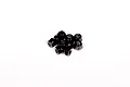 A small pile of black metal nyloc nuts for RC vehicles against a plain white background.
