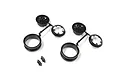 Two sets of black RC wheel rim components on plastic sprues with a small pile of mounting screws on a white background.