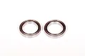 Two metal shielded ball bearings placed side by side on a plain white background.
