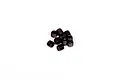A small pile of ten black metal grub screws with hexagonal drive sockets, isolated on a white background.