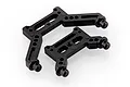 Two black plastic shock towers for UDI 1/16 scale RC vehicles, featuring multiple mounting holes and integrated body posts.