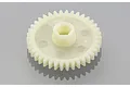 A white plastic spur gear for an RC car, featuring a central hexagonal mounting hole and a flat, circular design.