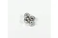 Four small silver-coloured steel nyloc nuts arranged in a cluster on a plain white background.