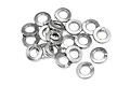 A pile of small silver-coloured metal spring washers on a white background.