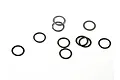 A collection of small, thin, circular metal washers scattered on a plain white background.