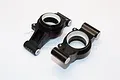 Two black aluminium RC rear hub carriers from GPM Racing, featuring white plastic inserts, set against a plain white background.