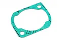 A green paper gasket for an RC engine cylinder head on a white background.