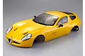 A yellow Killerbody 1/10 scale Alfa Romeo TZ3 Corsa RC car body shell viewed from a high angle against a grey background.
