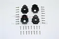 Four black aluminium portal drive housings and a set of mounting screws for RC cars, arranged on a white background.