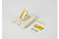 Unassembled 1/10 scale RC fire extinguisher kit with cream-coloured plastic parts, wheels, and a decal sheet on a white background.