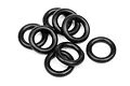 A pile of eight black silicone O-rings arranged on a white background.