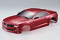 A red 1/10 scale RC car body shell of a 2011 Chevrolet Camaro, featuring detailed headlights, grille, and windshield wipers on a plain white background.