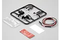 Killerbody 1/10 scale truck wing mirror kit including black plastic parts tree, clear lens tree, LED light wires, and adhesive mounting pads.