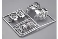 A chrome-plated plastic sprue containing light bucket parts for a 1/10 scale RC car model.