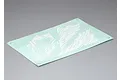 A rectangular sheet of white decals with abstract camouflage-like patterns on a light green backing paper, set against a plain grey background.