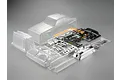 A clear, unpainted 1/10 scale RC car body shell set for a 1980 Nissan Skyline, including plastic parts trees, decals, and accessories.