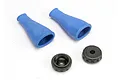 Two blue rubber shock dust boots and two black plastic shock caps on a white background.