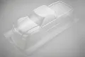 A clear, unpainted polycarbonate RC truck body shell for the HPI Jumpshot MT, shown from a high-angle studio perspective.