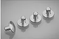 Four silver aluminium RC body shell posts arranged on a reflective grey surface.