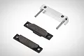 Rovan silver aluminium brake pad set for RC cars, featuring a metal mounting block with two pins and two brake pads with friction material.