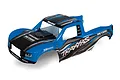 Traxxas Unlimited Desert Racer painted body shell in blue, black, and grey with sponsor decals.