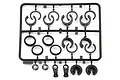 A black plastic parts tree containing various RC shock spacers and small suspension components for HPI Savage models.