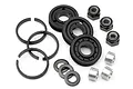 A set of HPI Racing shock piston parts including plastic pistons, metal spacers, locking nuts, and C-clips on a white background.