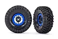 Two Traxxas 1.9 inch Canyon Trail RC crawler tires mounted on black and blue beadlock-style wheels against a white background.