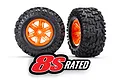 Two Traxxas X-Maxx RC monster truck wheels with black all-terrain tires and bright orange rims, featuring an 8S RATED logo overlay.