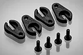 Four black plastic LED light clips and four matching black screws arranged on a light grey surface.