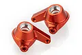 Two orange anodized aluminium steering hub carriers for RC cars, shown from an elevated angle against a white background.