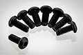 Eight black metal button head screws arranged in a semi-circle on a white background.
