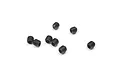 A small group of seven black metal grub screws with hexagonal sockets, scattered on a plain white background.
