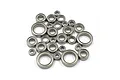 A collection of various sized metal ball bearings for RC cars arranged on a white background.