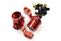 Two red anodized aluminium steering hubs for Kyosho Mini-Z, accompanied by small black screws and brass bushings on a white background.