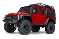 A red Traxxas TRX-4M Land Rover Defender RC rock crawler on a white background.