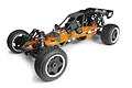 HPI Baja 5B 1/5 scale petrol RC buggy in orange and black with off-road tires and a roll cage, viewed from a high angle.